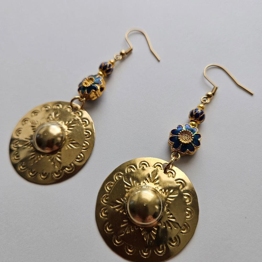 
                  
                    Gold-filled blue floral motif enamel bead, gold-filled alternating blue drop motif, gold-plated brass spacers, gold-plated stainless steel ear wire, brass agong medallion earrings.
                  
                