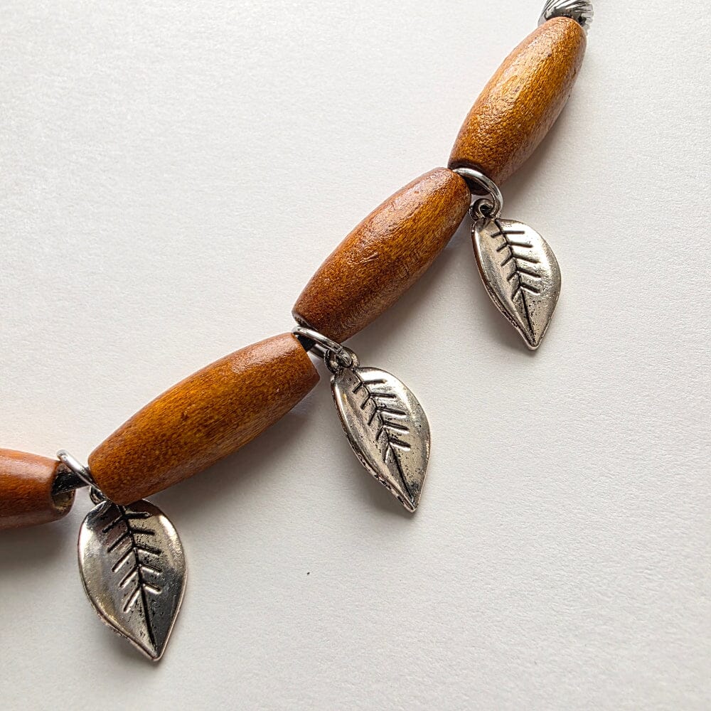 Silver leaves and wood tubes strung together
