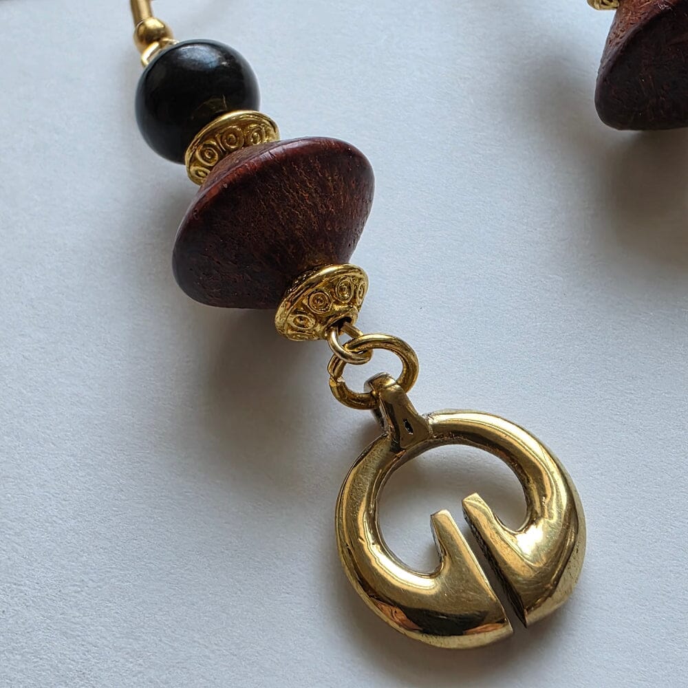 Ling Ling-O with vintage wood conical beads, gold colored conical beads, and black carabao horn with gold-plated earwire.