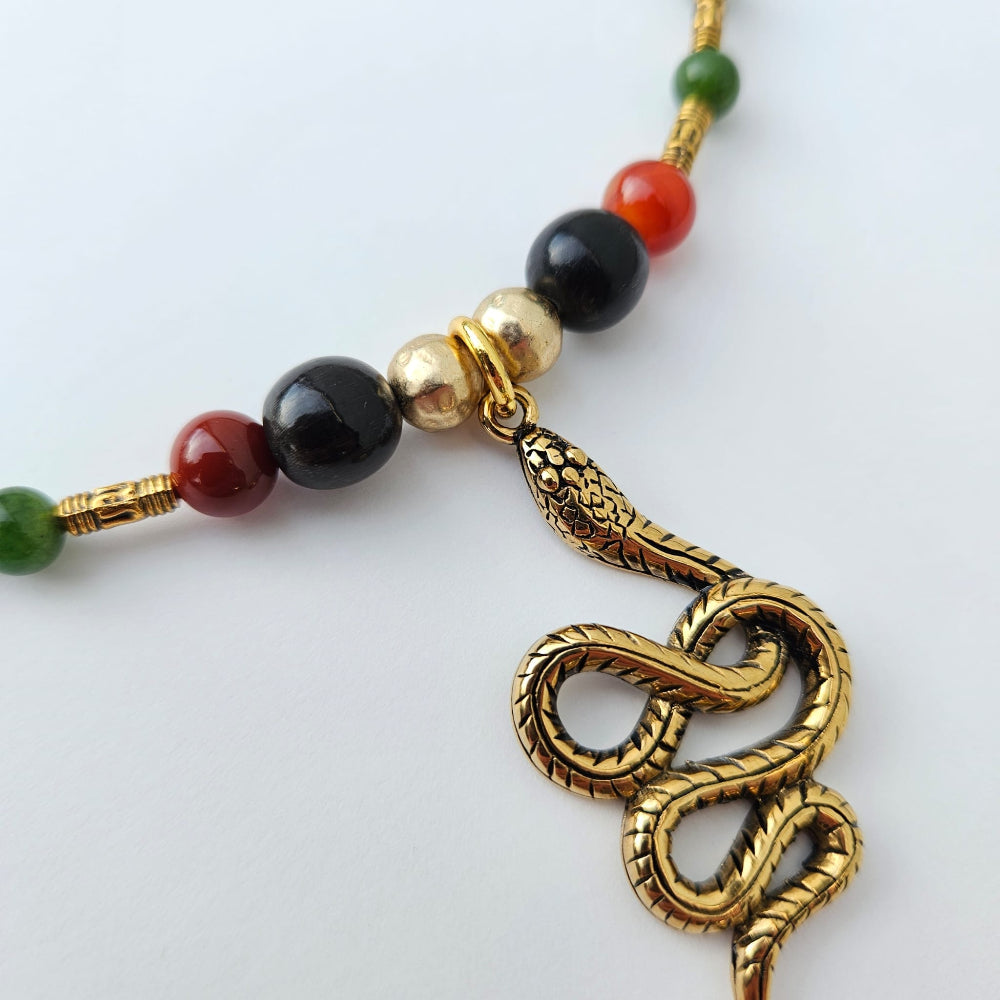 Serpent Goddess Stainless steel pendant with carabao horn, fire agate, and maw sit sit Burmese jade amuletic necklace.