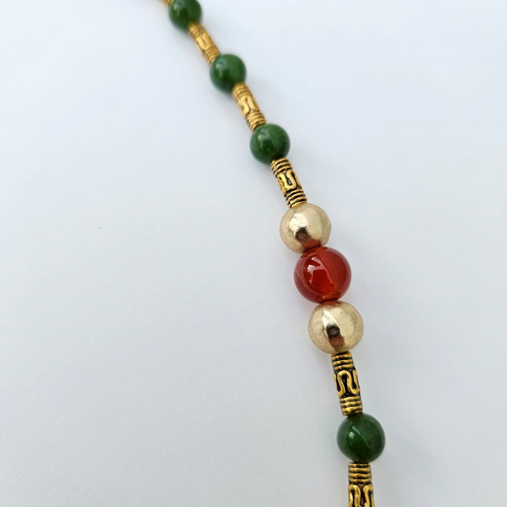 
                  
                    Maw sit sit Burmese jade, gold colored metal tubes with gold accent beads and fire agate.
                  
                