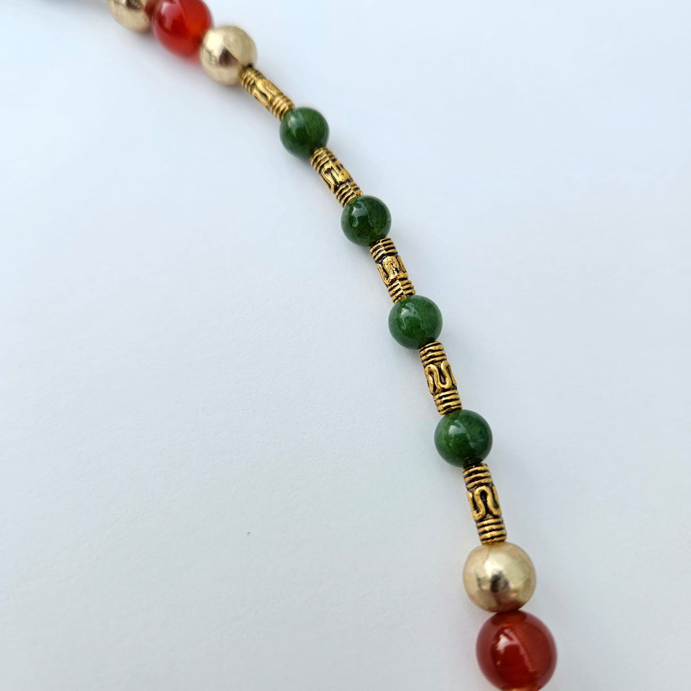 
                  
                    Maw sit sit Burmese jade, gold colored metal tubes with gold accent beads and fire agate.
                  
                